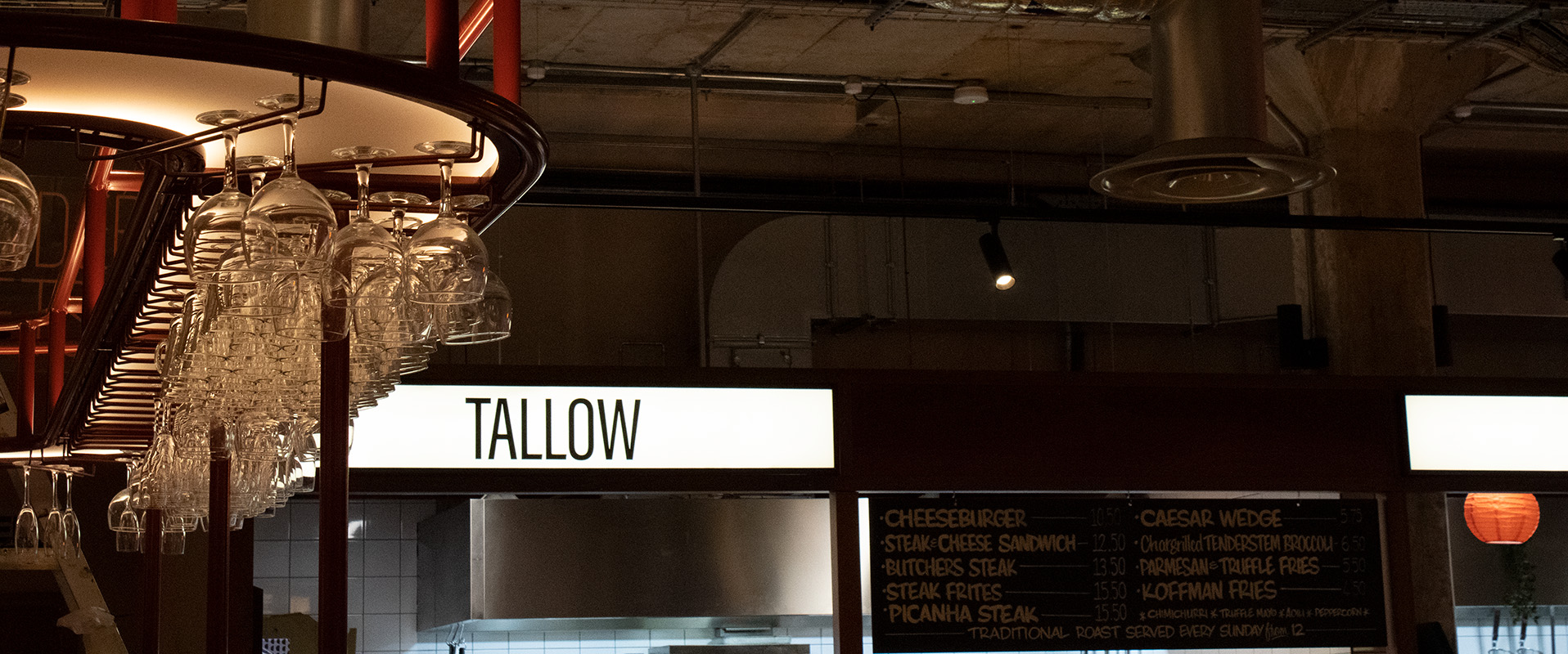Photo of light box with text "Tallow" situated in the middle of the sign.